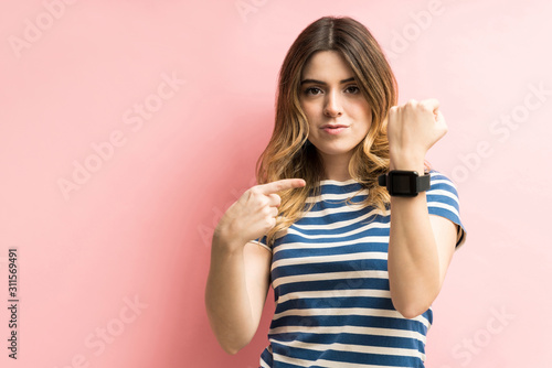 Bild auf Leinwand Caucasian Woman Flaunting Her Wearable Computer At Studio