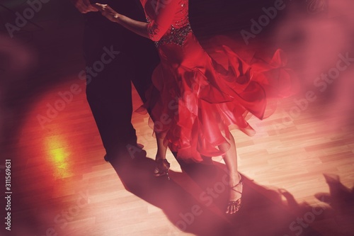 Fotografie, Obraz Man and woman dancing Salsa on dark