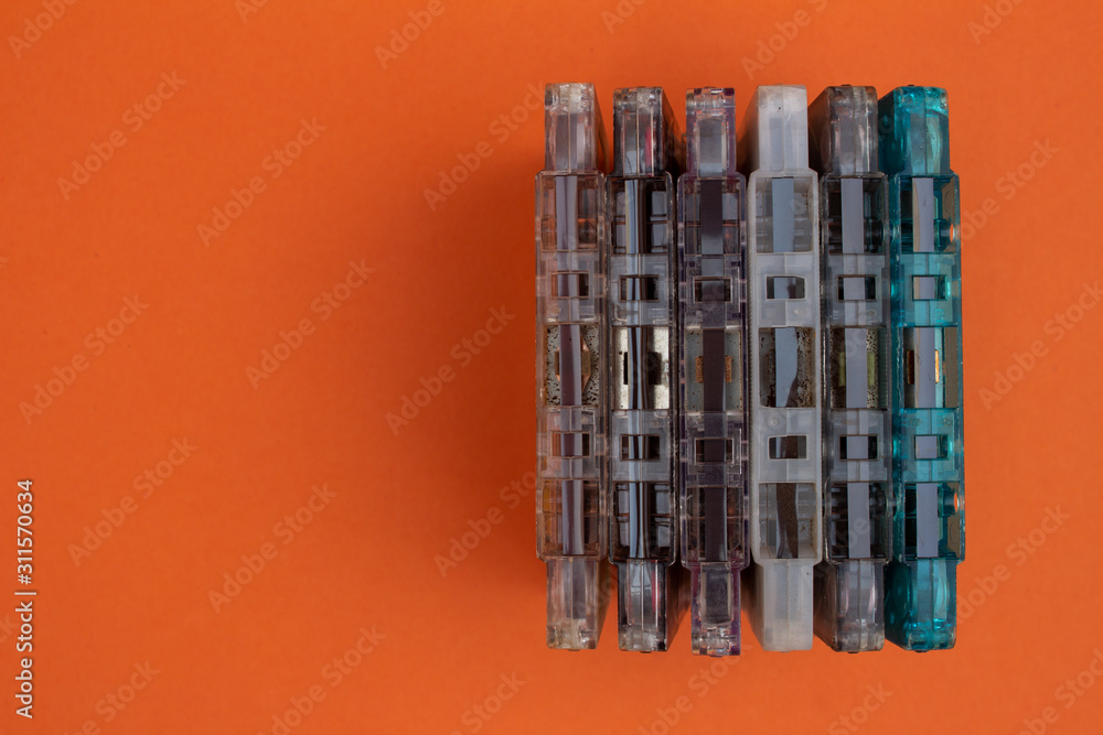 Top view of audio cassettes stacked together. Obsolete music technology and devices