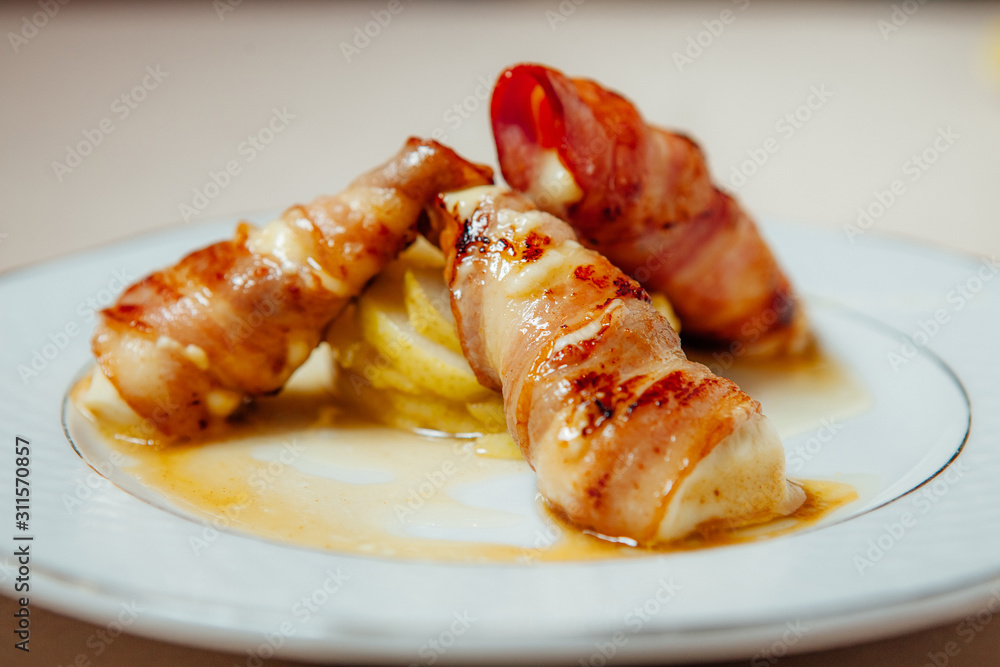 Suluguni cheese wrapped in bacon Suluguni cheese wrapped in bacon