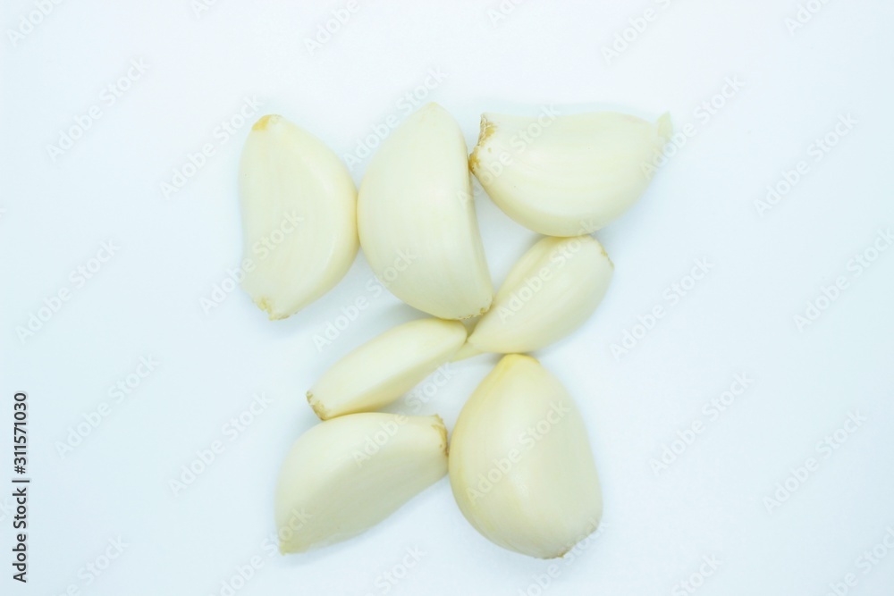 Peeled garlic located on a white background Peeled garlic located on a white background