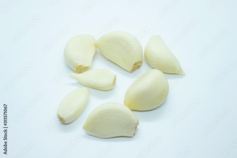 Peeled garlic located on a white background Peeled garlic located on a white background