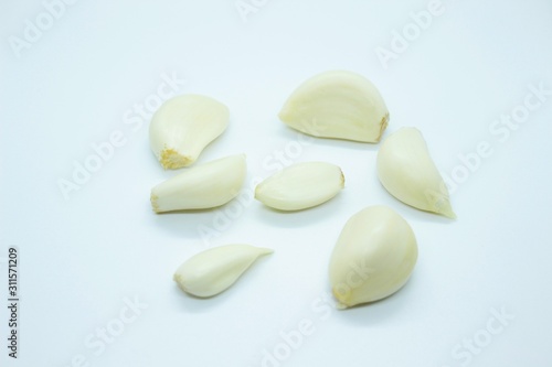 Peeled garlic located on a white background