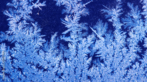 Frosty winter window. Blue Frostwork Background  Ice Crystals on Glass