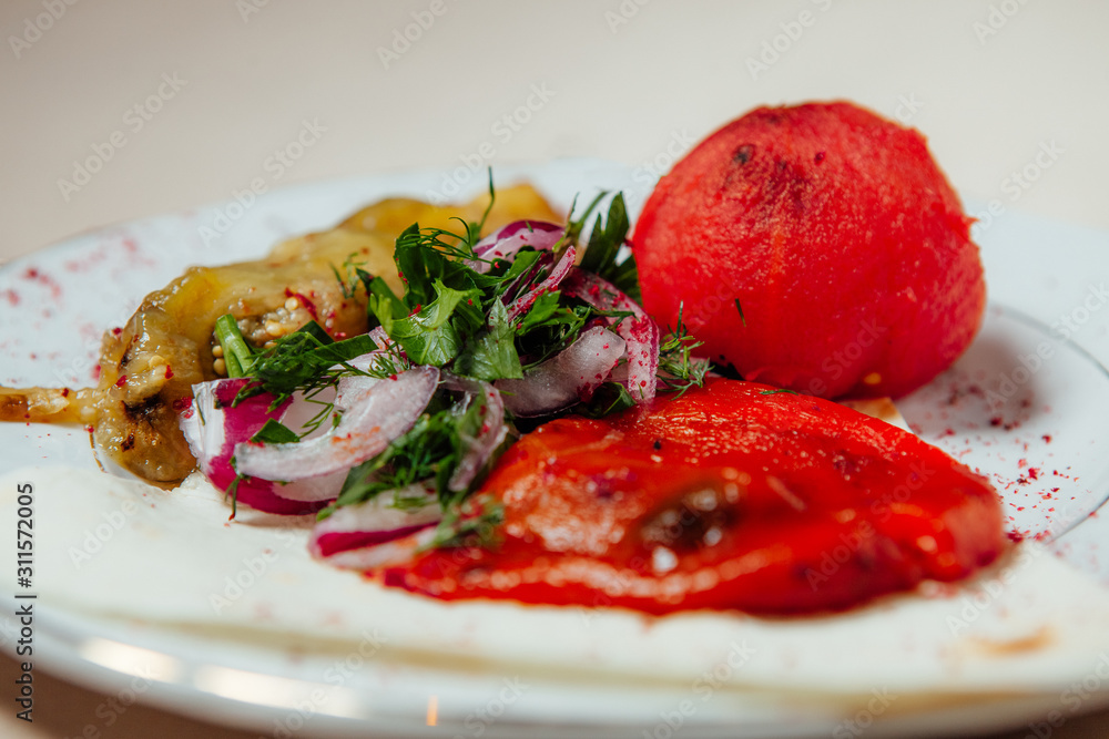 Vegetables fried on coals on a white plate Vegetables fried on coals on a white plate