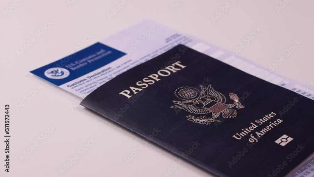 American passport with a customs declaration form on a white background. Close-up American passport with a customs declaration form on a white background. Close-up