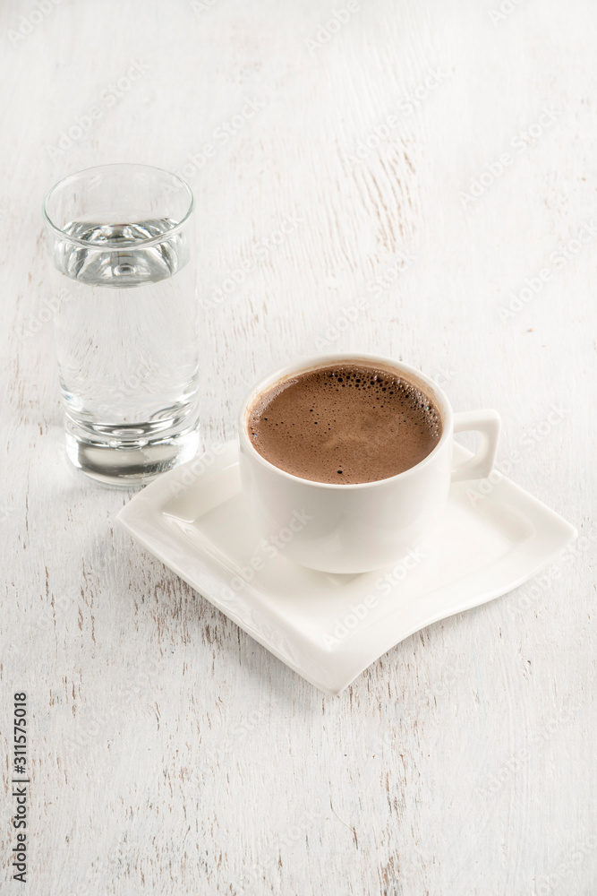 Turkish coffee served with a glass of water on table Stock Photo | Adobe  Stock