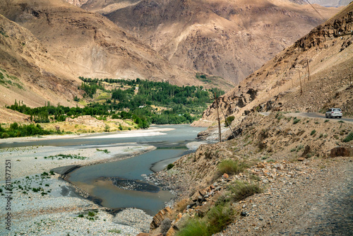 Fototapeta Naklejka Na Ścianę i Meble -  View on Wakhan Corridor in Afghanistan behind the Wakhan river. Taken from Pamir highway on Tajikistan side.