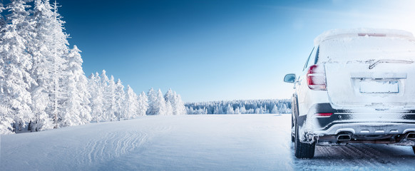 White car on winter road in the morning