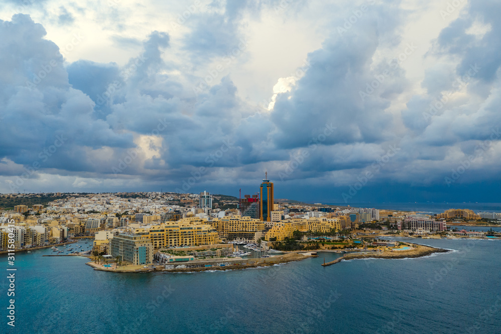 Aerial landscape view of St. Julian's city. Winter, storm clouds, Portomaso marina. Malta