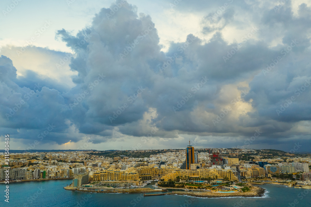 Aerial landscape view of St. Julian's city. Winter, storm clouds, Portomaso tower. Malta island