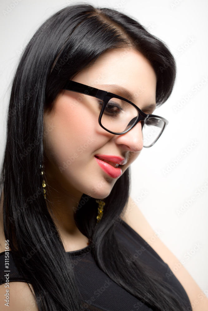 Young brunette womans face with extended lashes in glasses Young brunette womans face with extended lashes in glasses