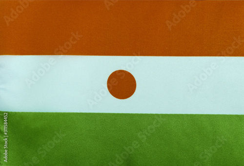 Free Download Republic of Niger flag on textile base close up - GFXLoad