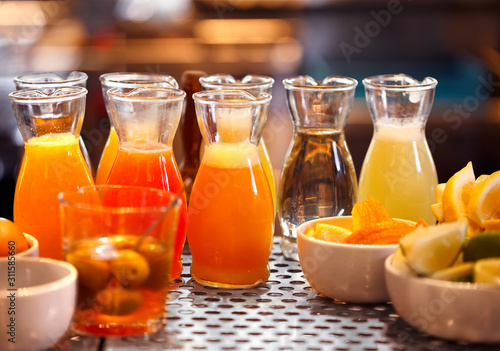 Juice in glass bottles and fruits at a local bar
