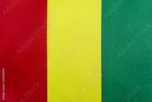 Flag of the Republic of Guinea on a textile basis close-up
