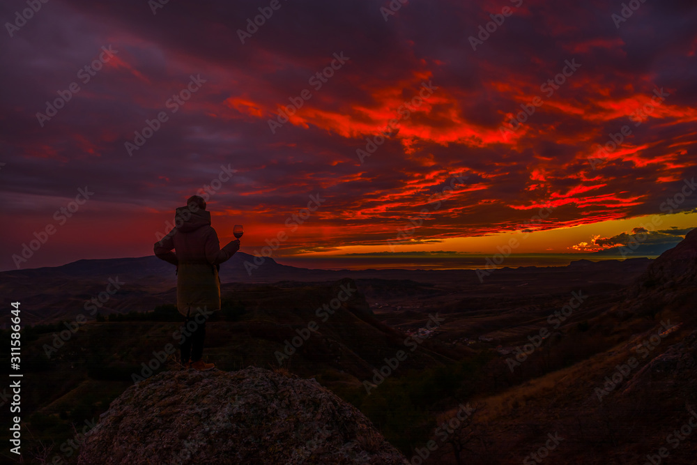 Girl in the mountains with wine