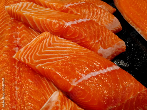 Fresh colorful raw salmon fish fillets in the supermarket for cooking