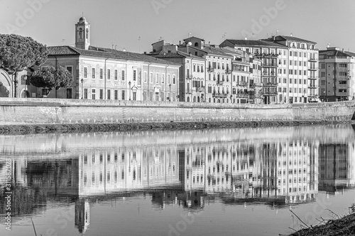 Sunset on the banks of the Arno River, Pisa, Italy.