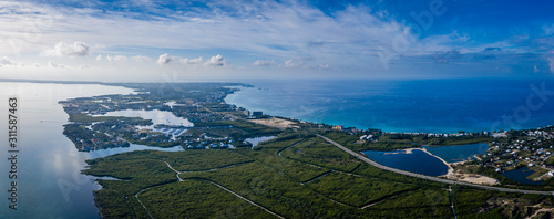 aerial drone footage of the island of grand cayman in the cayman islands in the clear blue and green tropical waters of the caribbean sea