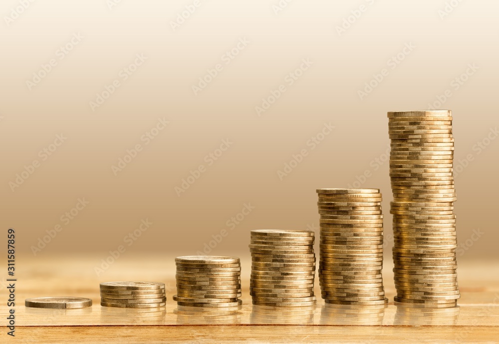 Golden coins on wooden table, investment and money Golden coins on wooden table, investment and money