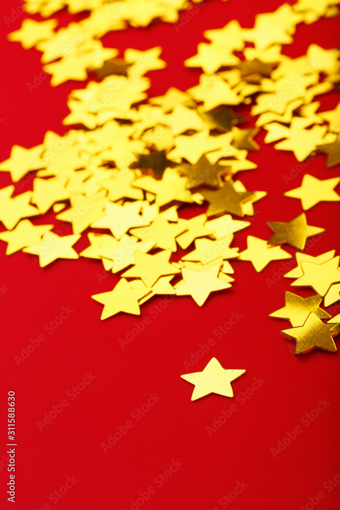 A scattering of Golden stars on red background. The concept of greeting cards, headlines and web site.