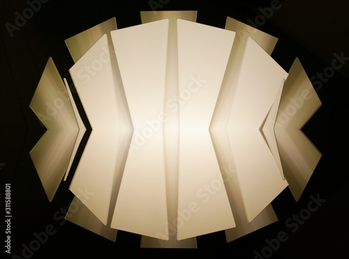 Polygonal pattern of metal panels resembling decorative wall with angular structure or architectural surfaces. Abstract modern architecture or interior background with irregular geometric composition.