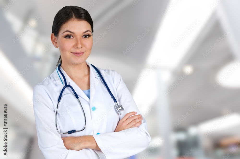 Young woman doctor holding stethoscope on background Young woman doctor holding stethoscope on background