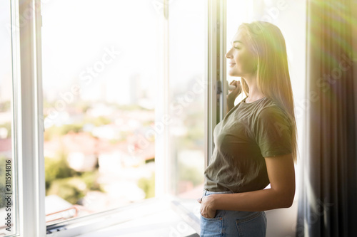 Happy woman open plastic windows for fresh air indoor photo