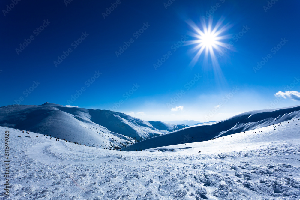 Landscape of snow winter valley surrounded by hills on sunny day Landscape of snow winter valley surrounded by hills on sunny day