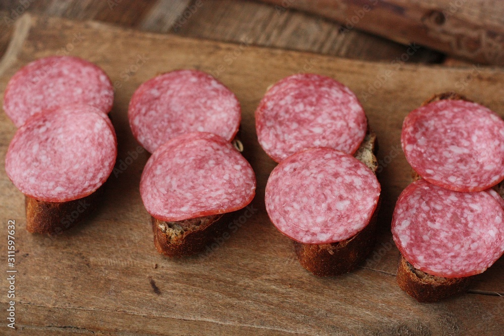 Sandwiches with bread and sausage on the table Sandwiches with bread and sausage on the table