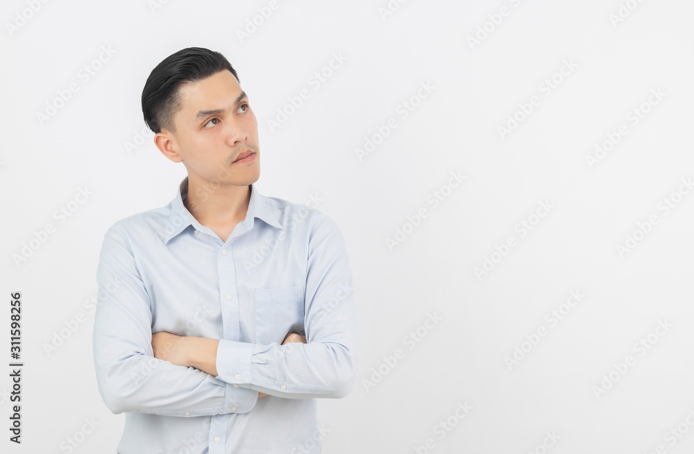 Young handsome asian man thinking an idea while looking up with arms crossed isolated on white background. Young handsome asian man thinking an idea while looking up with arms crossed isolated on white background.
