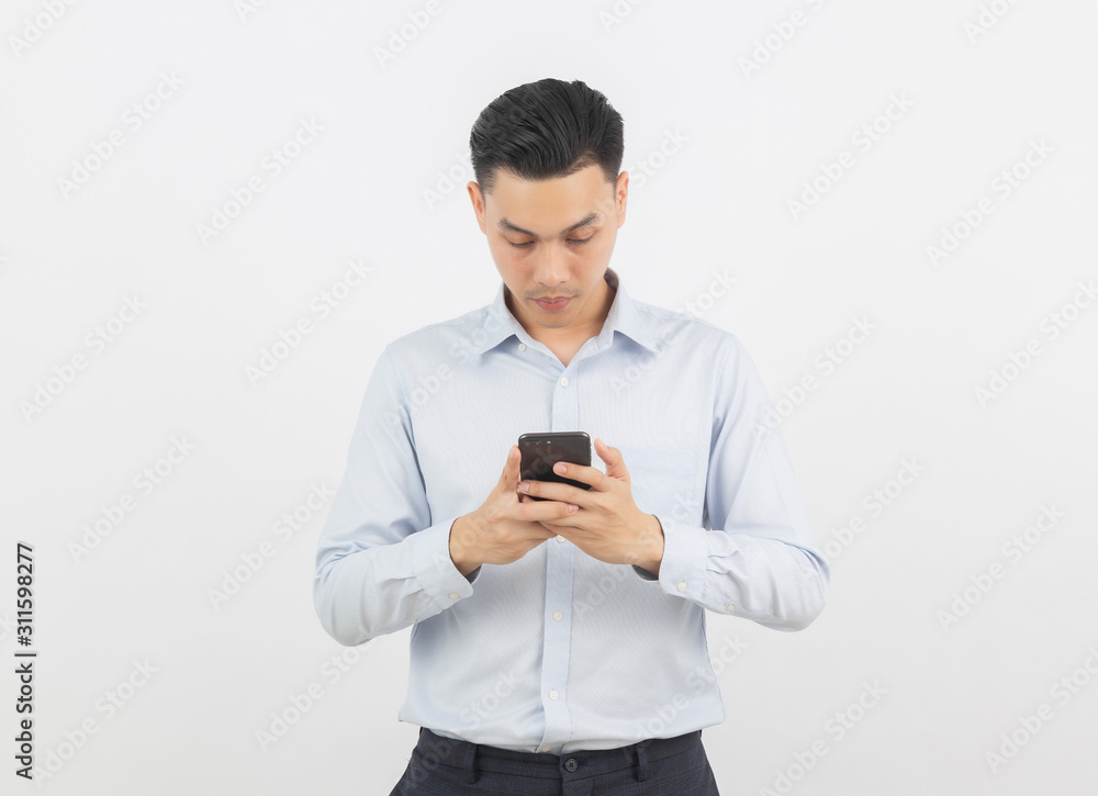 Young handsome asian business man playing smartphone with smiling isolated on white background. Young handsome asian business man playing smartphone with smiling isolated on white background.