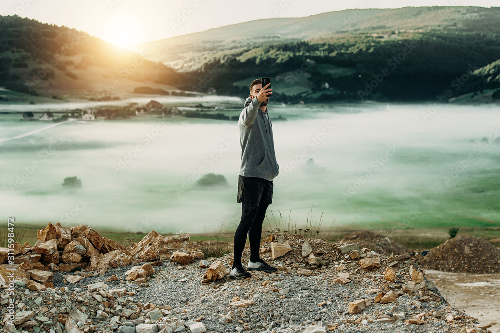Man making selfie on top of mountain Man making selfie on top of mountain