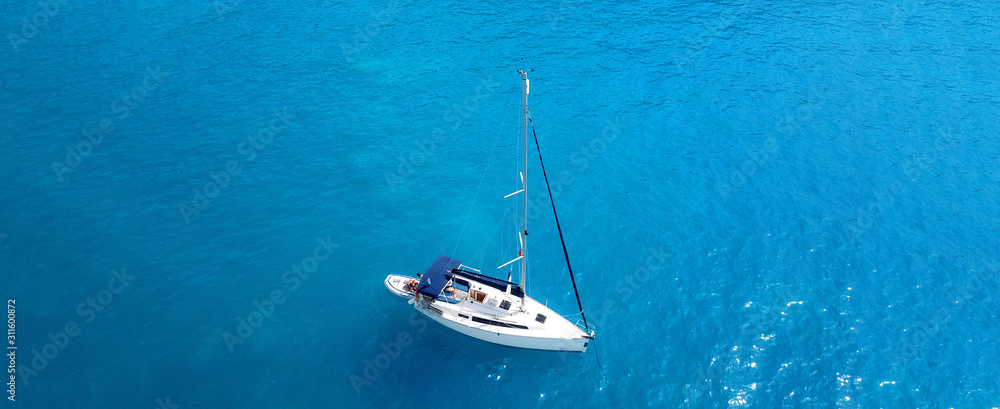 Fototapeta premium Aerial drone ultra wide photo of sail boats docked in paradise bay of Fiskardo, Kefalonia island, Ionian, Greece