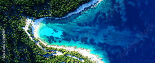 Aerial drone ultra wide photo of secluded turquoise exotic paradise bay with sandy beach