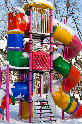 colorful playground covered in snow