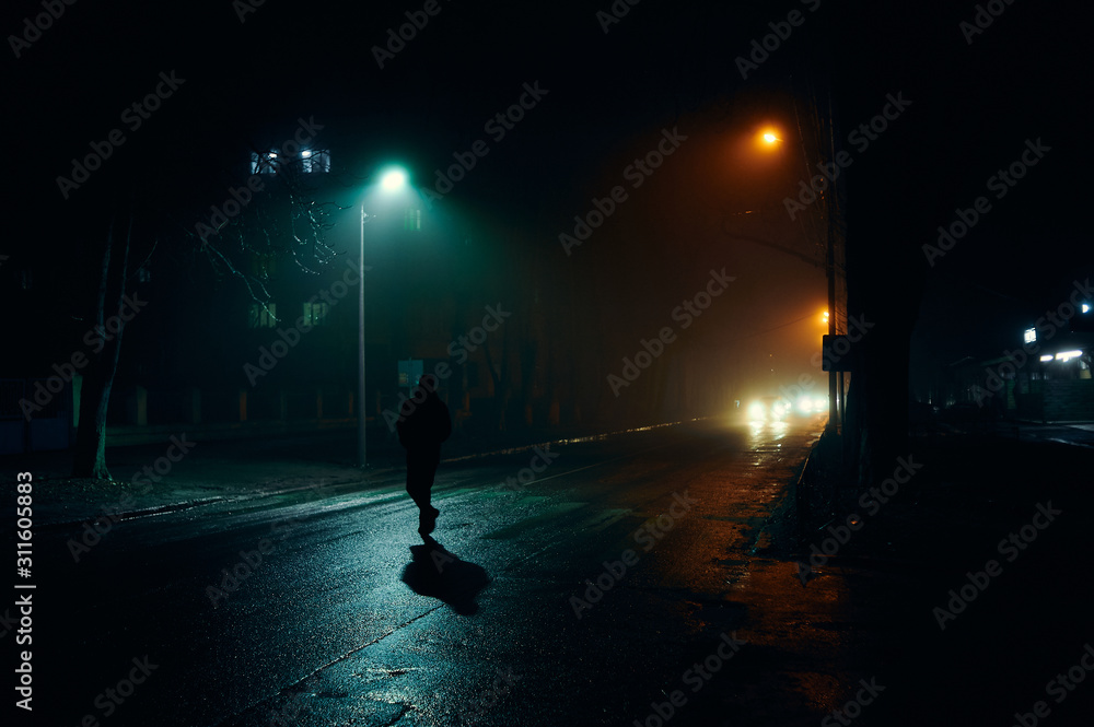 fog in the night city after rain, car headlights fog in the night city after rain, car headlights