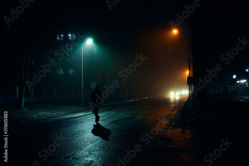 fog in the night city after rain, car headlights