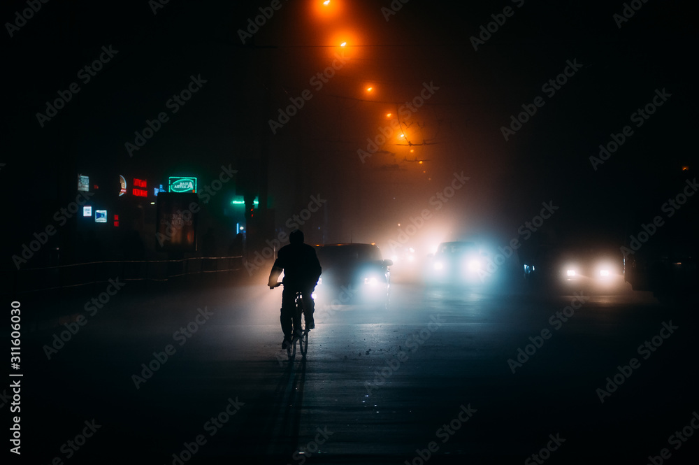 fog in the night city after rain, car headlights