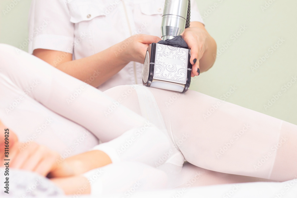 lpg girl body massage in spa. The girl is given a hardware massage, she is wearing a special jumpsuit for massage. cavitation, cellulite, fat loss. vacuum roller massage. maniple lpg girl body massage in spa. The girl is given a hardware massage, she is wearing a special jumpsuit for massage. cavitation, cellulite, fat loss. vacuum roller massage. maniple