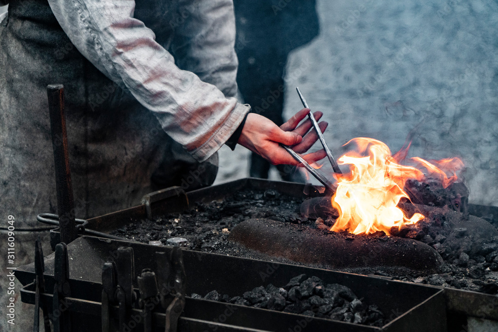 Fototapeta premium Fire of blacksmith in the blacksmith's workshop
