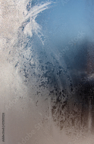 The texture of hoarfrost on the freezing window.