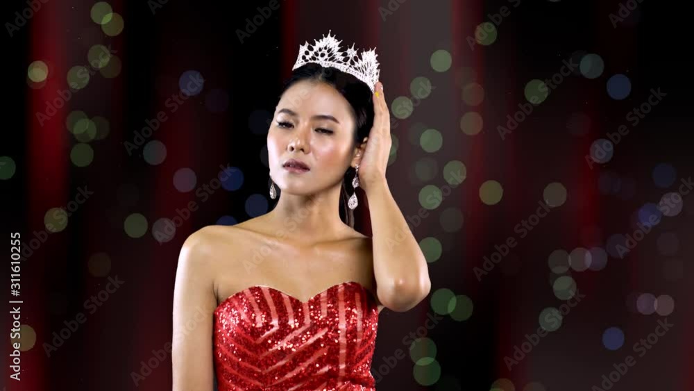 Miss beauty pageant queen with Asian features and red gown smiles and ...