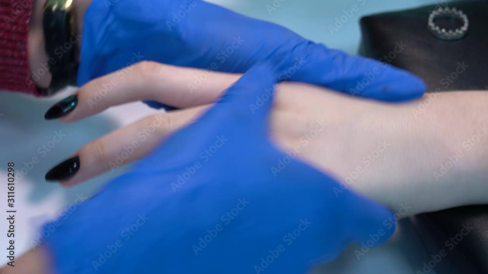 Manicurist doing massage of hands of client after fresh manicure. Real time 4k video footage. Manicurist doing massage of hands of client after fresh manicure. Real time 4k video footage.