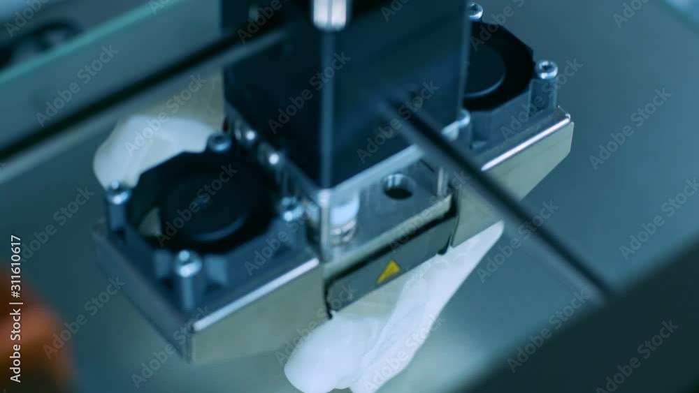 Modern 3D printer printing figure close-up macro.Automatic three dimensional 3d printer performs plastic white color modeling in laboratory. 3d-printing processing with white background Modern 3D printer printing figure close-up macro.Automatic three dimensional 3d printer performs plastic white color modeling in laboratory. 3d-printing processing with white background