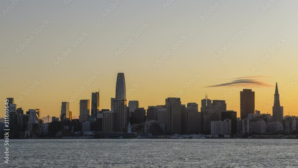Time-Lapse of the San Francisco Bay Area business district and the bay seen from Treasure Island from day to night with lights coming on the buildings Time-Lapse of the San Francisco Bay Area business district and the bay seen from Treasure Island from day to night with lights coming on the buildings