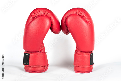 Concept of strength, victory, competition - boxing gloves are facing each other against a light background © Мар'ян Філь