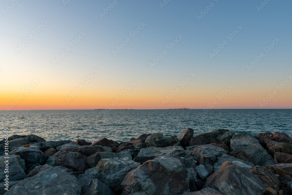 Sunset at the rocky beach shot at summer evening 
