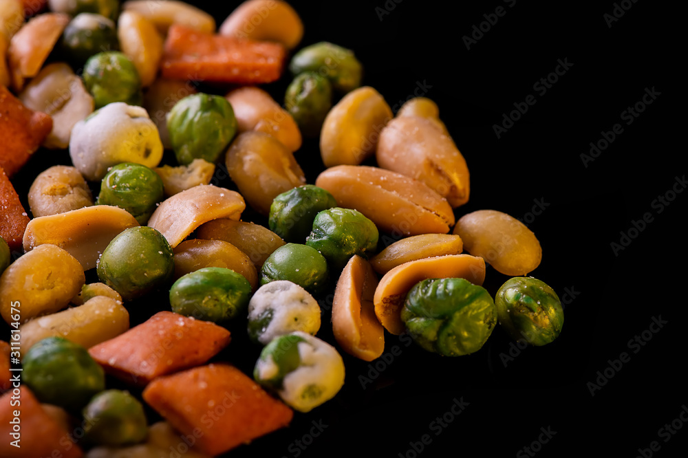 A pile of mixed nuts, healthy snack, on black background A pile of mixed nuts, healthy snack, on black background