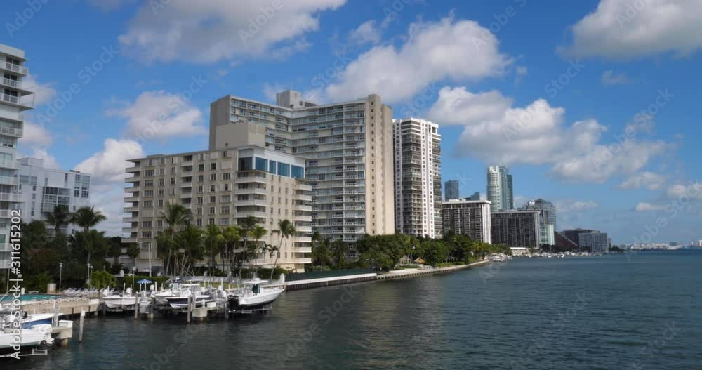 A slow motion tracking shot of typical Miami apartment or condominium buildings on a sunny summer day. A slow motion tracking shot of typical Miami apartment or condominium buildings on a sunny summer day.
